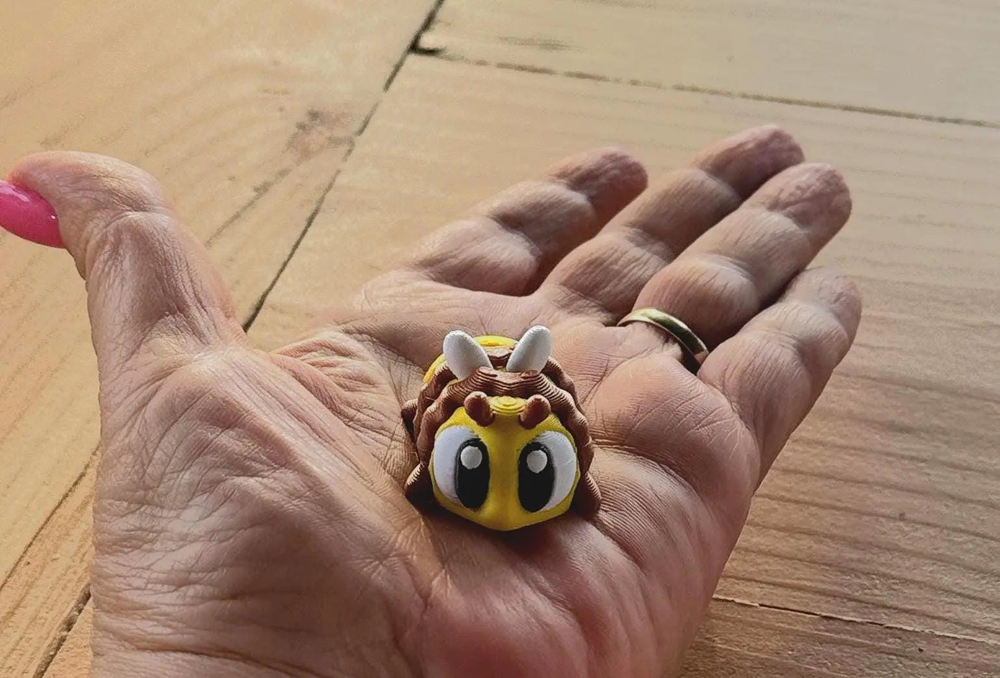 3D printed bee fidget toy set with beehive and eight articulated bees displayed on a white background
