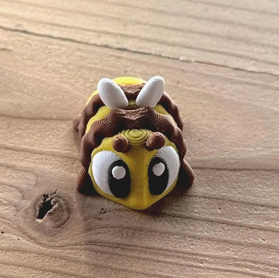 3D printed bee fidget toy set with beehive and eight articulated bees displayed on a white background
