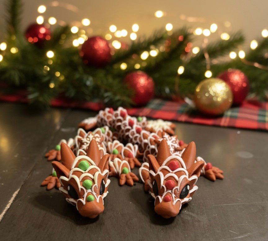 Decorative dragon-shaped cookies on a dark surface with Christmas decorations in the background.