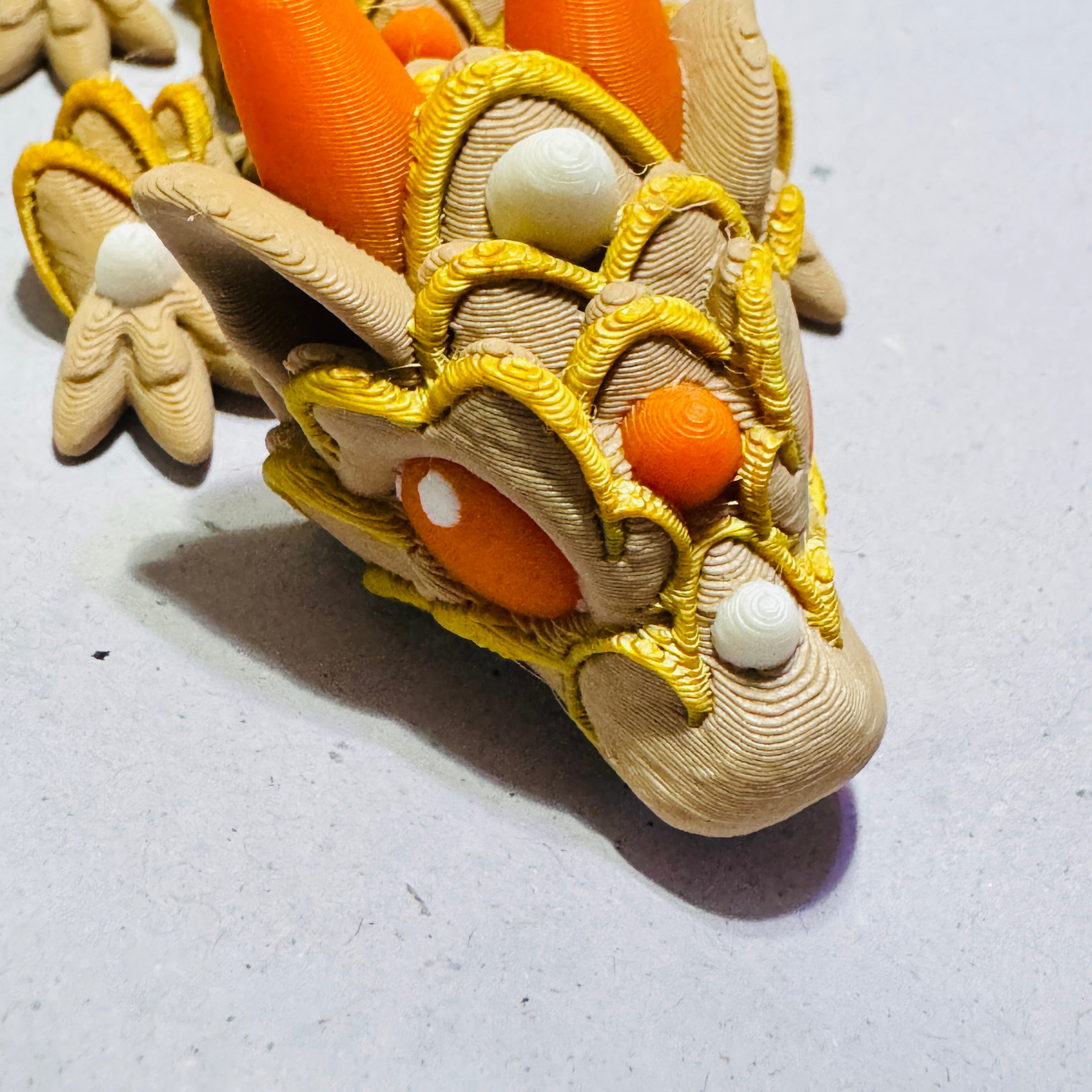 Custom color 3D printed pumpkin dragon in green and gold, fully articulated fantasy fidget toy collectible