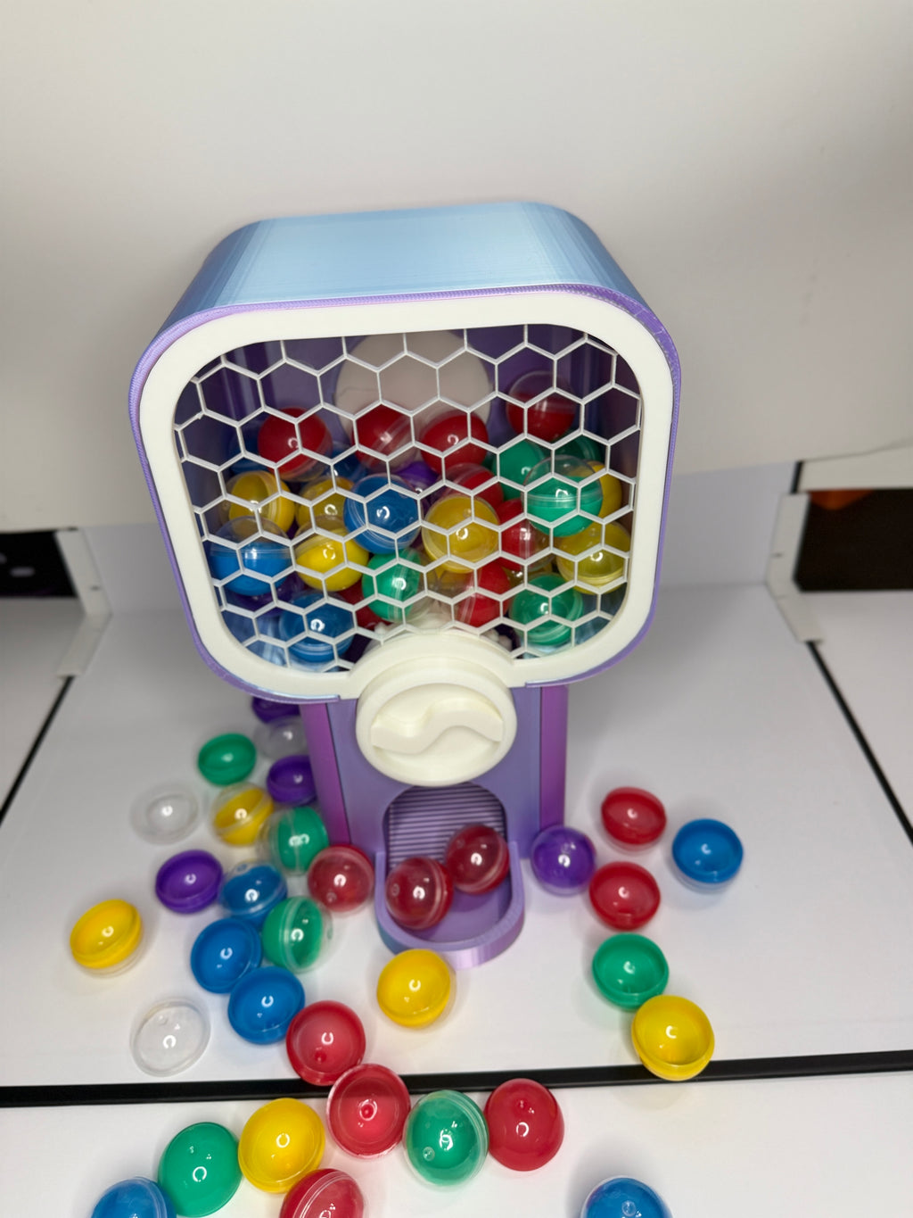 Custom 3D printed miniature vending machine shown from side angle with toy capsules