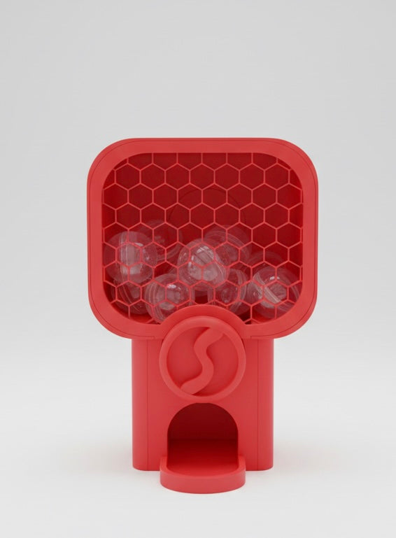 Red silicone ice cube tray with clear cubes on a white background