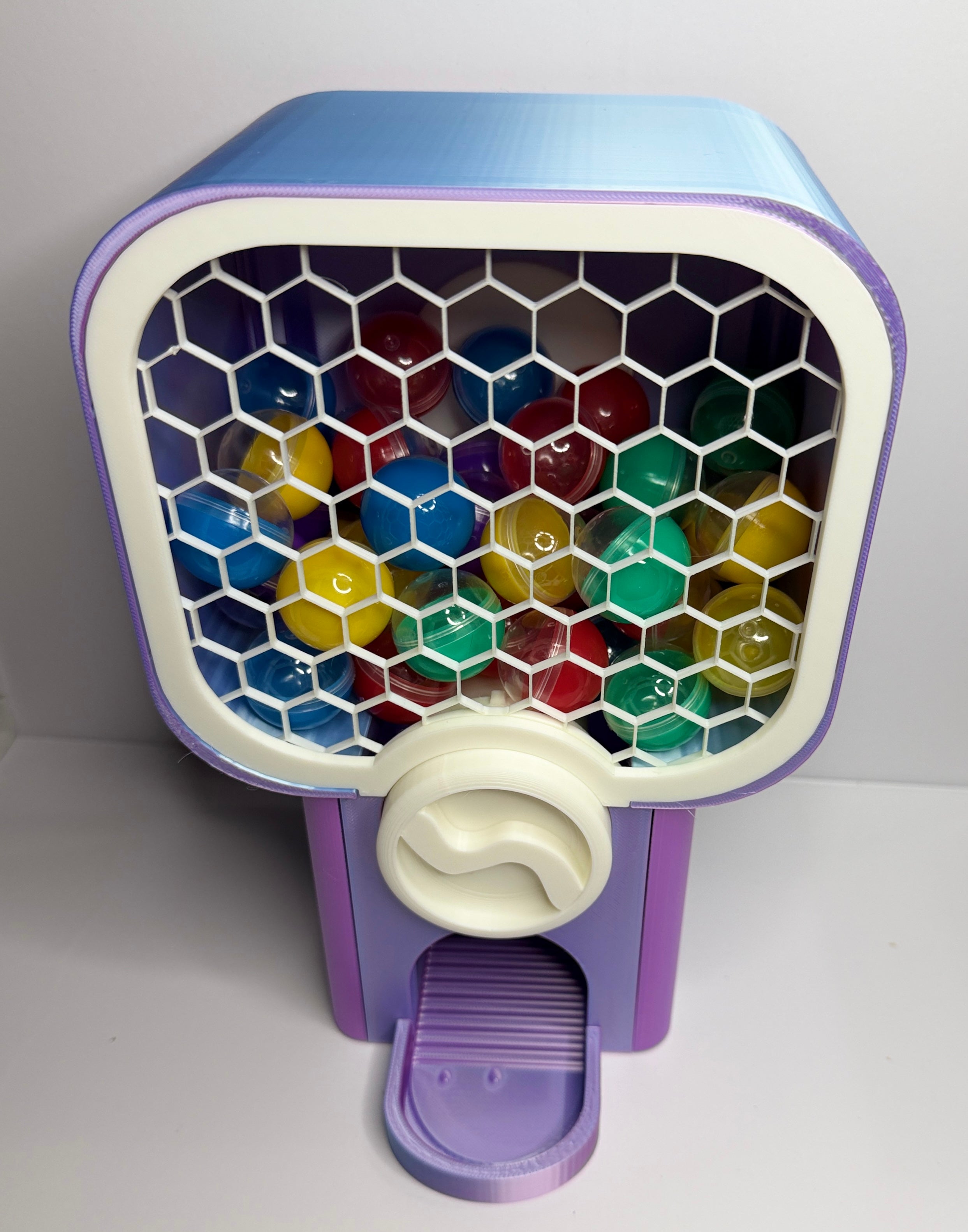 Close up of 3D printed vending knob and capsule dispenser mechanism