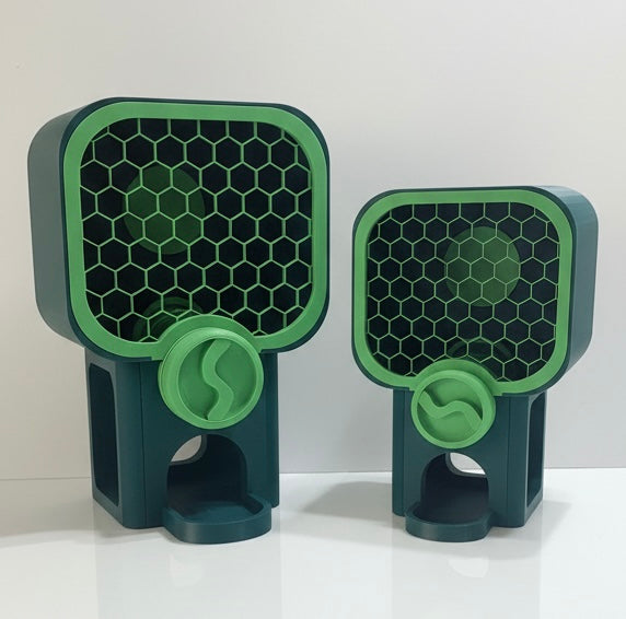 Two green and black honeycomb-patterned stands on a white surface with a light gray background