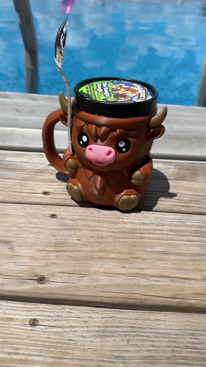 3D-printed Highland Cow pint holder with shaggy texture; Cozy brown cow pint cozy on rustic table with flowers