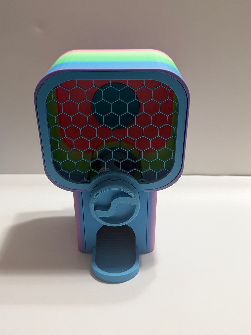 Colorful toy with a honeycomb design on a white surface