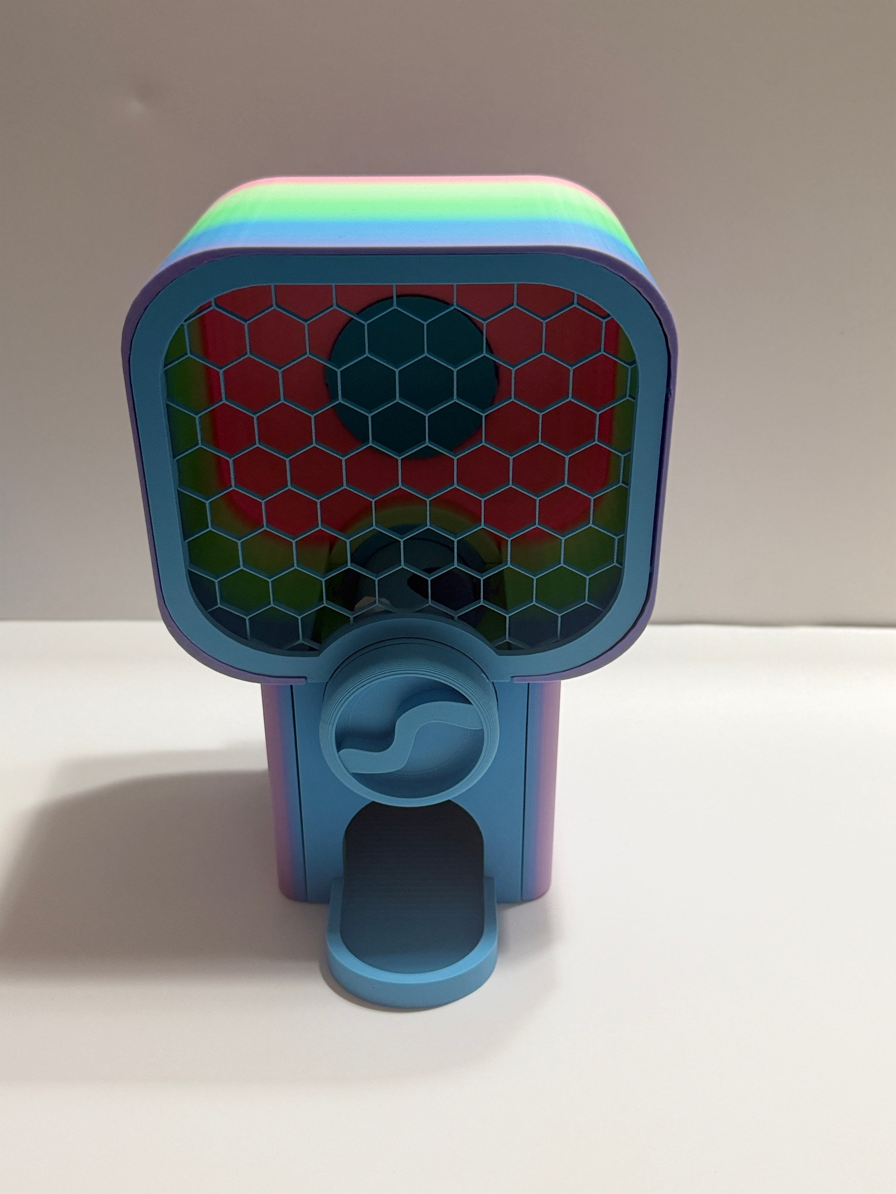 Colorful toy with a honeycomb design on a white surface