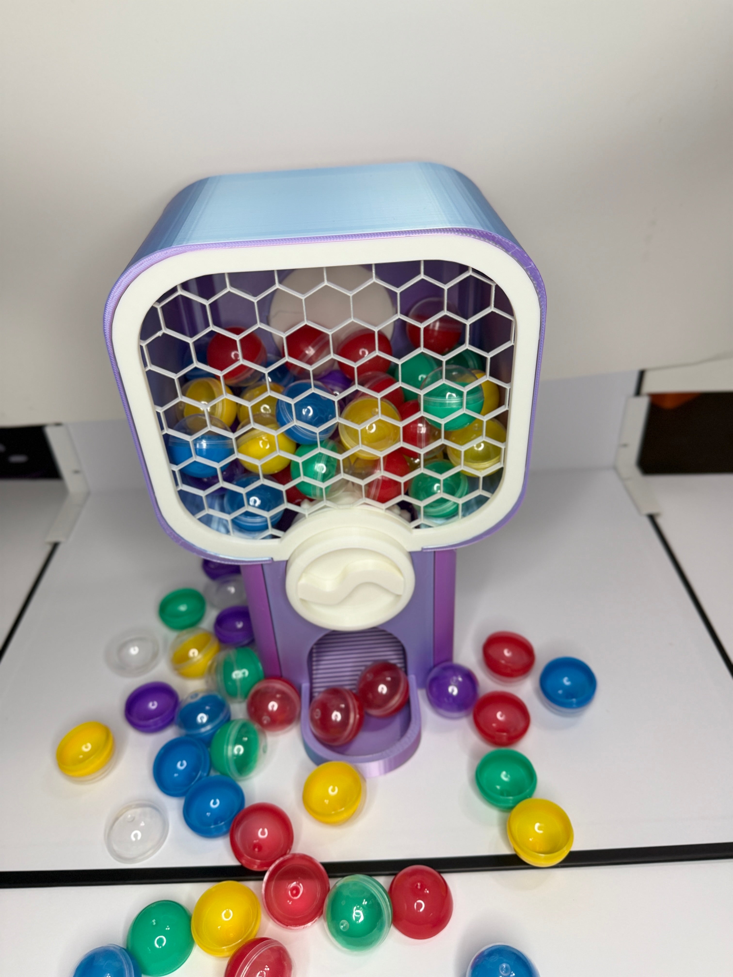 Custom 3D printed miniature vending machine shown from side angle with toy capsules